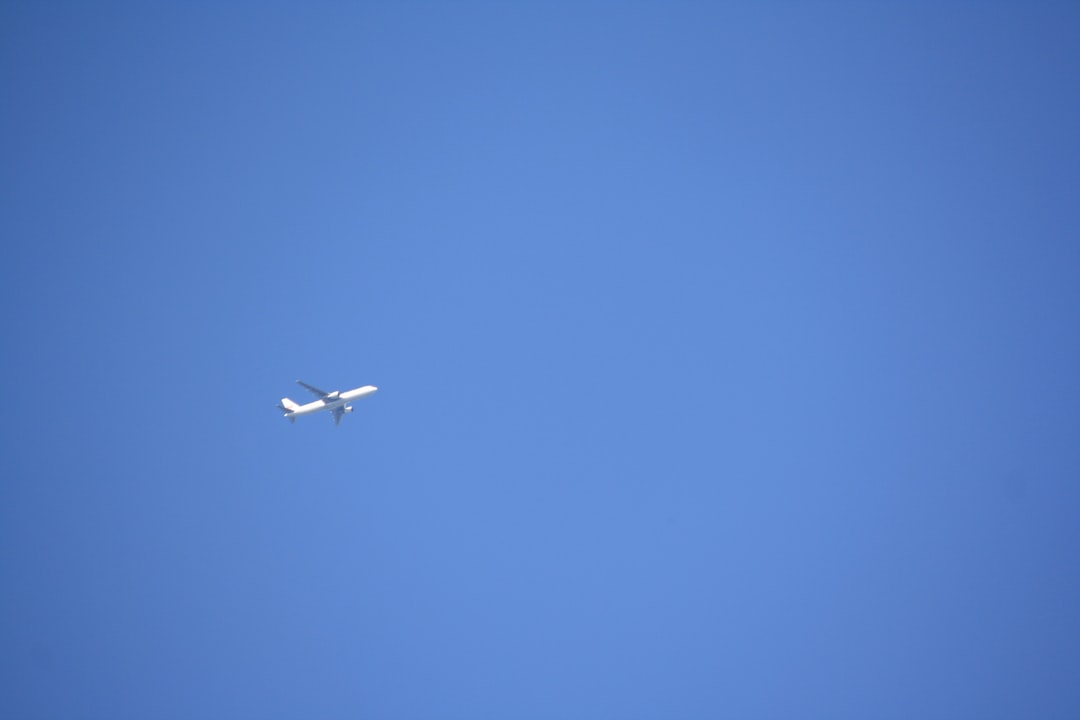 an airplane is flying high in the sky