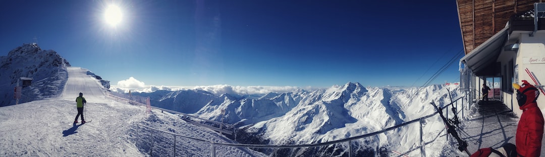 a man standing on top of a snow covered mountain