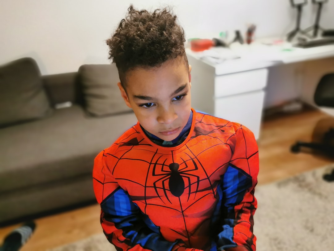 a young boy wearing a spider man costume