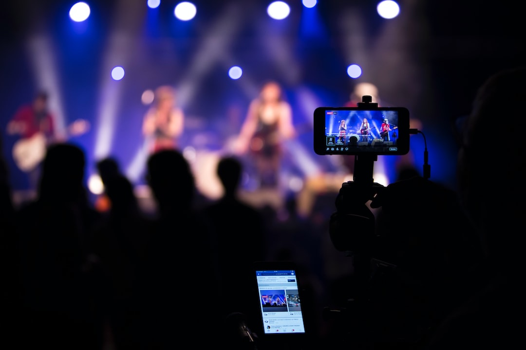 people taking videos during concert