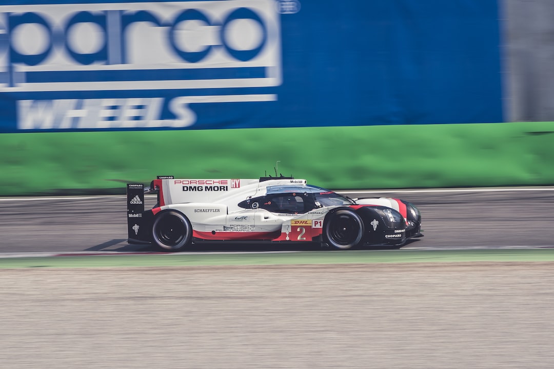 white and black sports car racing on track