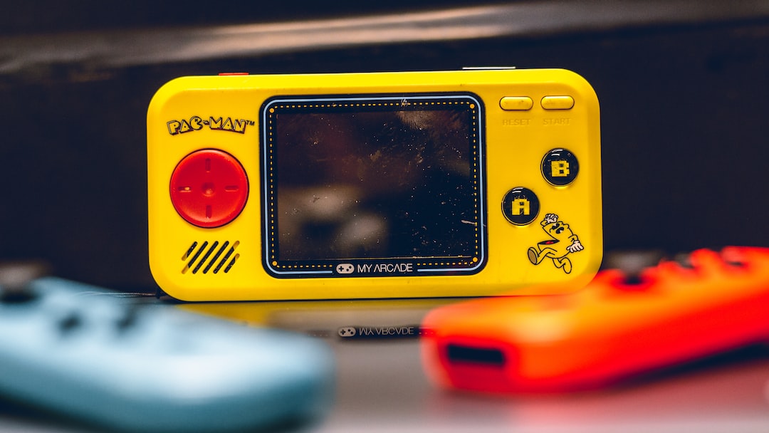 a yellow gameboy sitting on top of a table