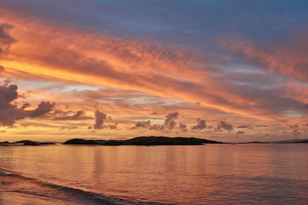 island and ocean during golden hour