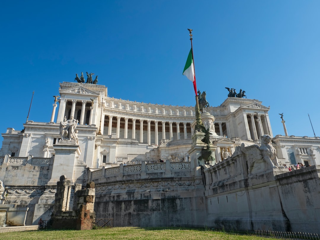 a building with statues and a flag