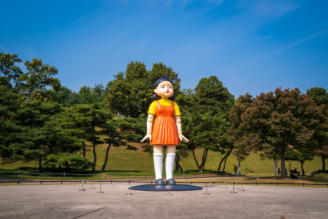 a large statue of a woman in an orange dress