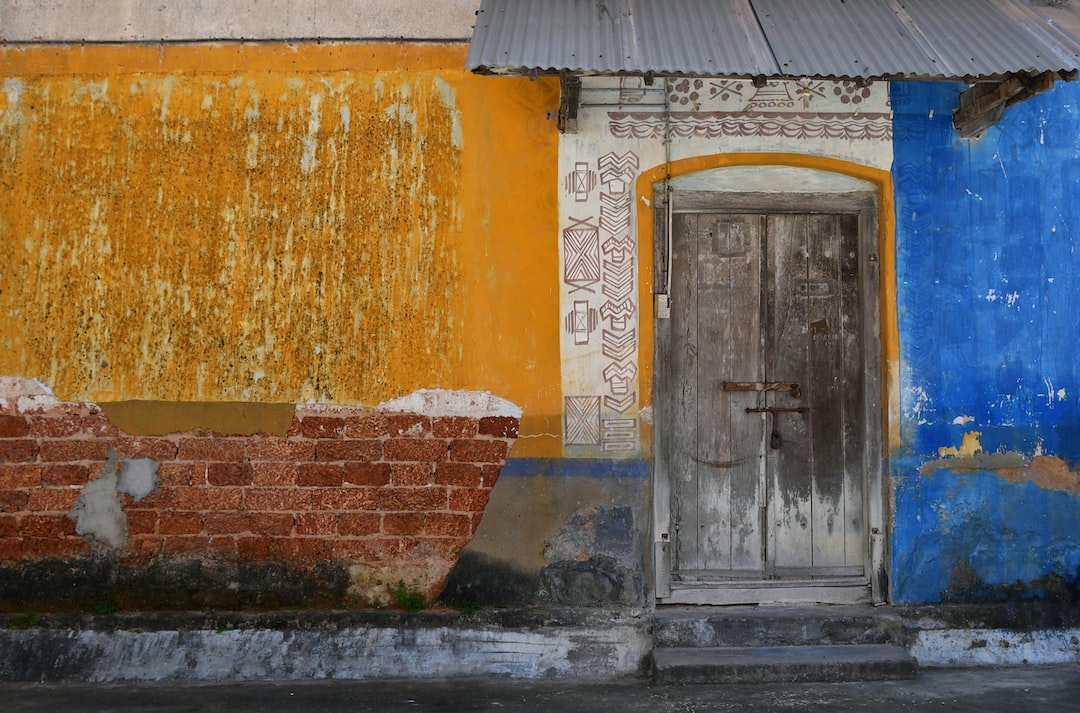 a building with a door and a brick wall