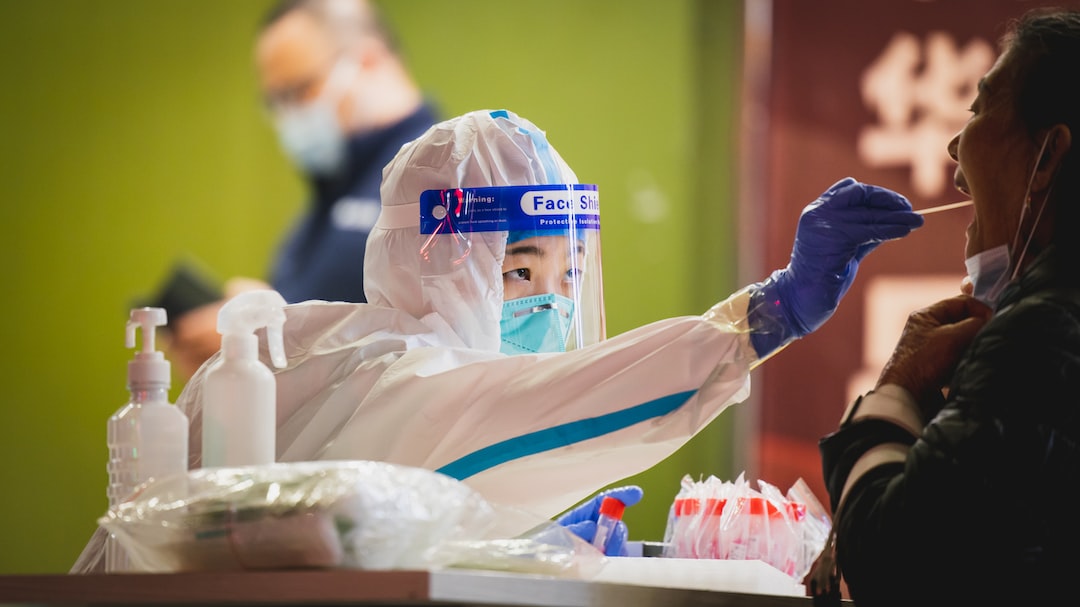 a person wearing a protective suit and holding a toothbrush