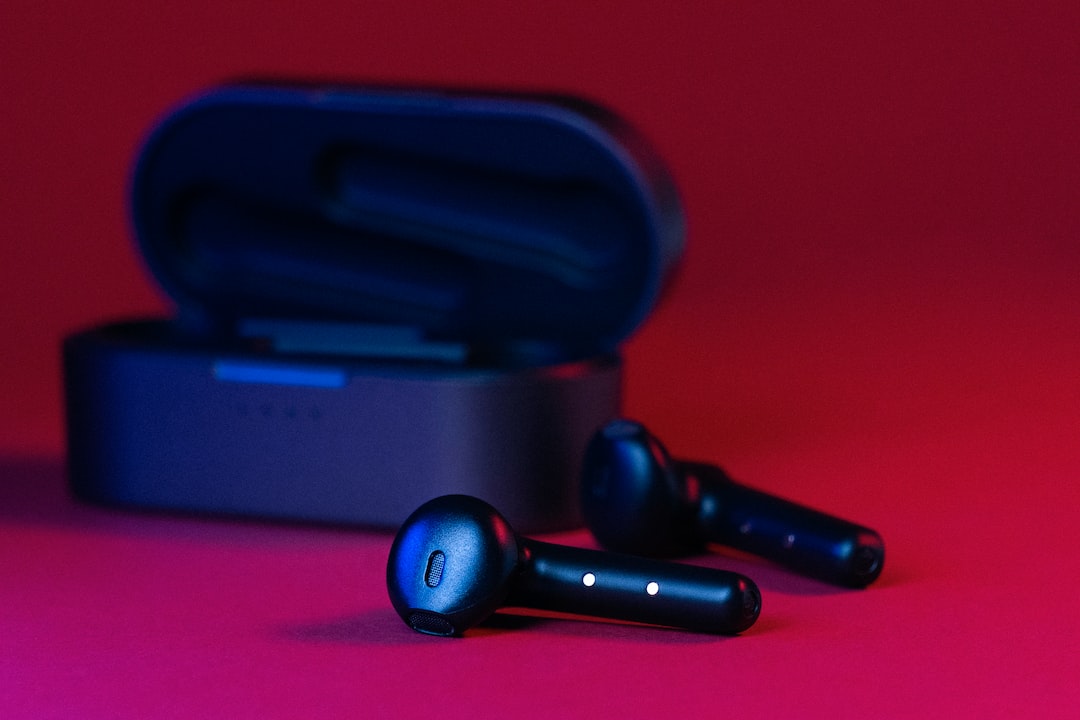 black and gray bluetooth earbuds