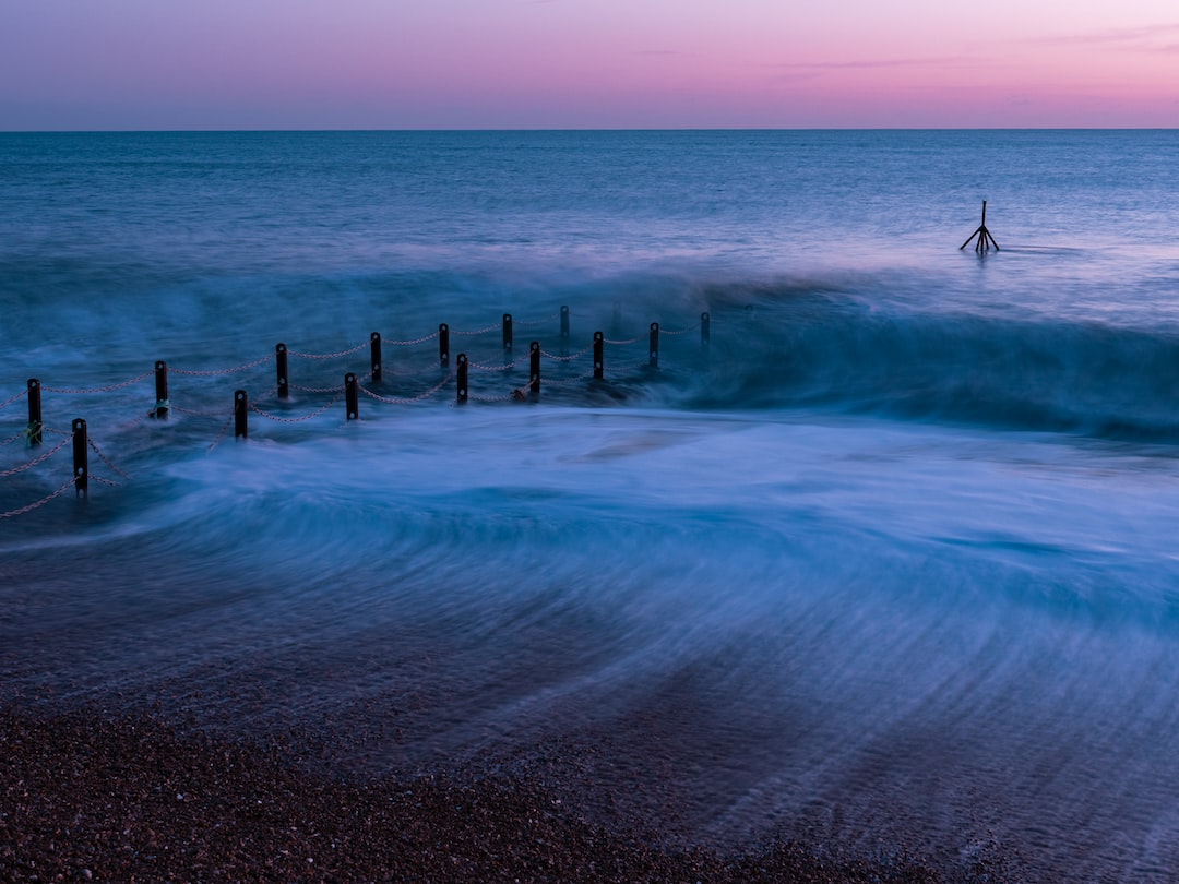 a person standing on a beach next to the ocean