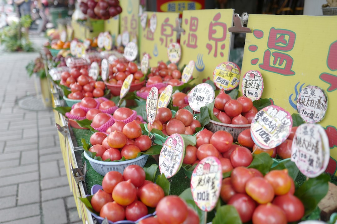 a row of baskets filled with lots of tomatoes