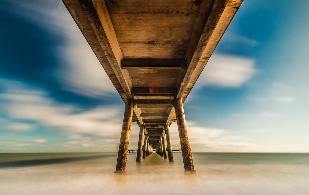 brown wooden dock above body of water in timelapse photography