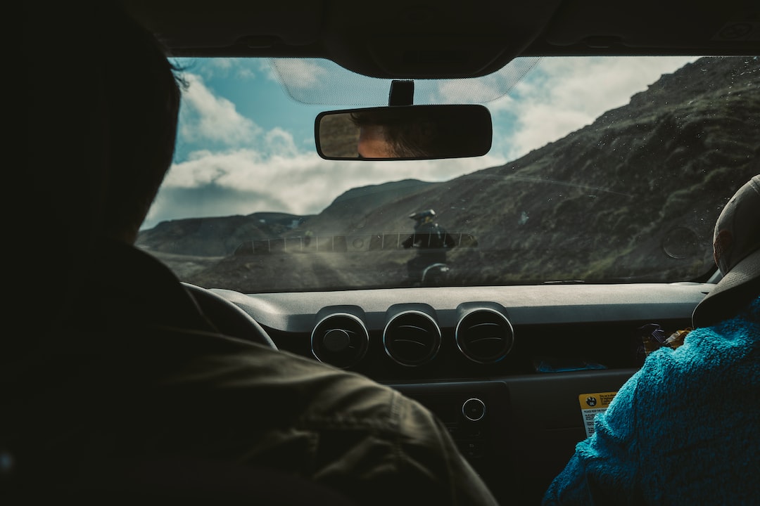 a man driving a car down a mountain road