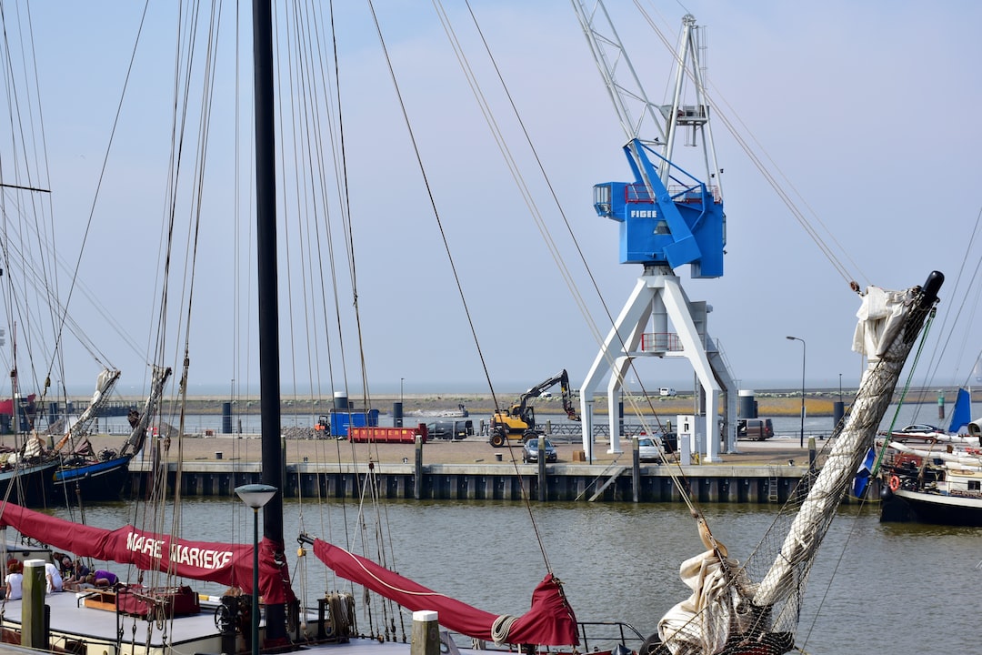 a group of sailboats docked at a pier