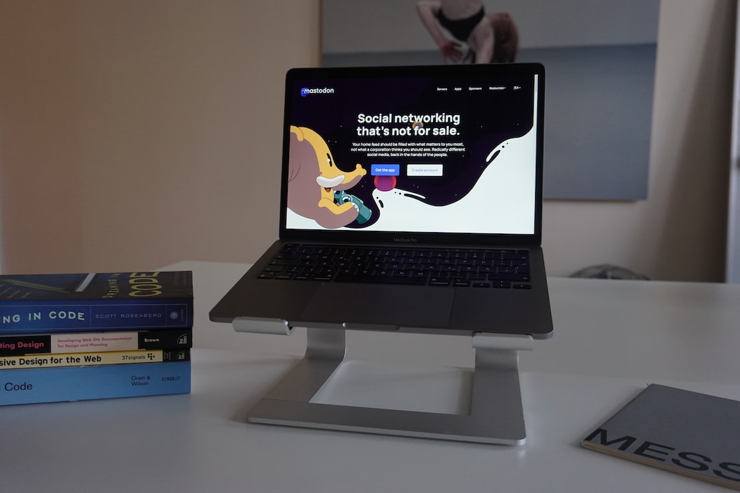 a laptop computer sitting on top of a white desk