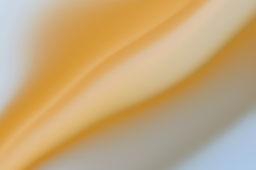 a blurry image of a yellow and white background