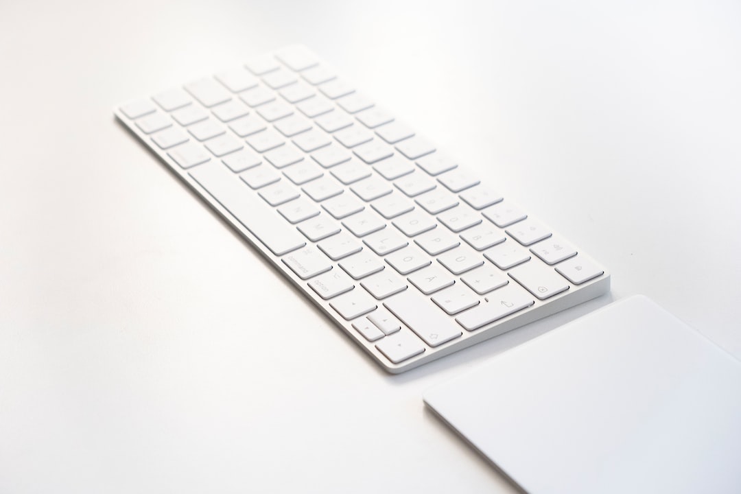 white apple keyboard on white table