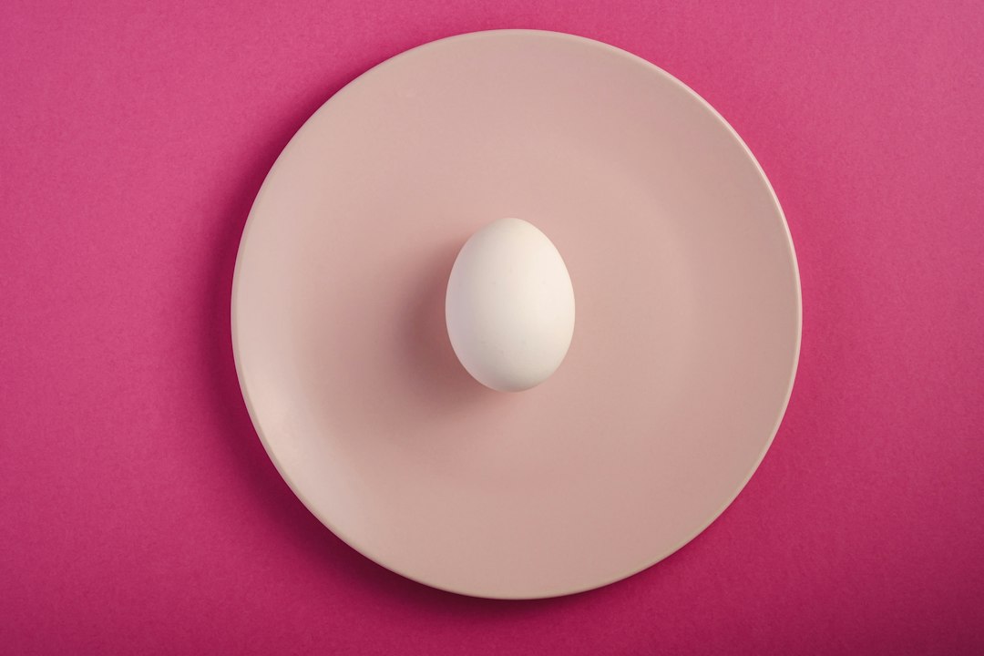 white round plate on pink textile