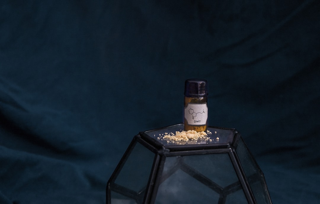 white labeled jar on top of cube ball on blue textile