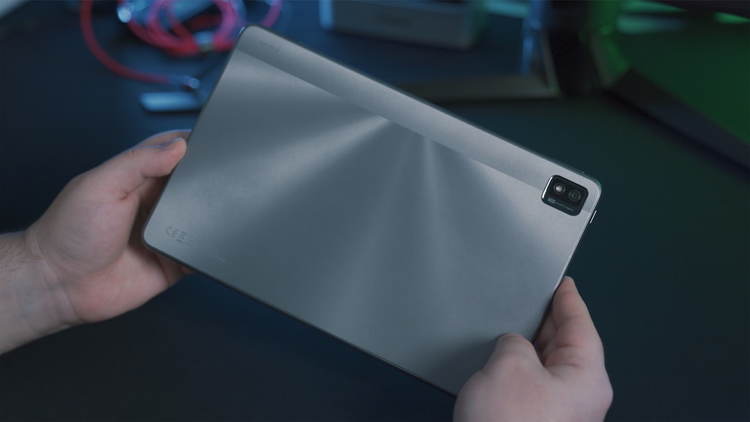 person holding gray tablet computer