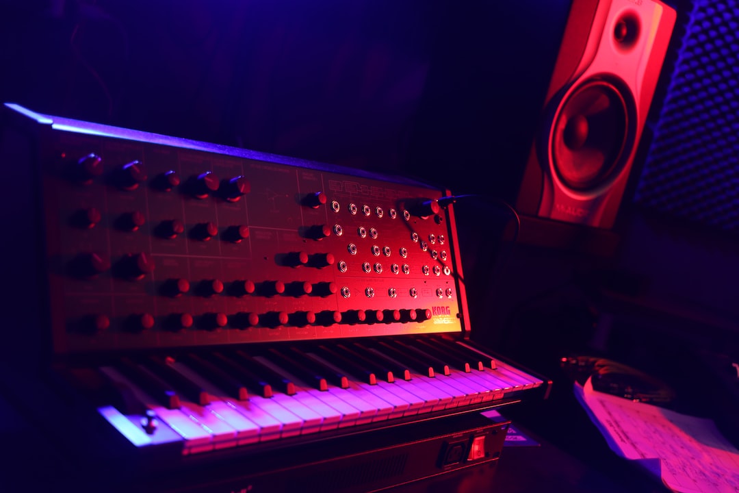 a keyboard and a speaker in a dark room