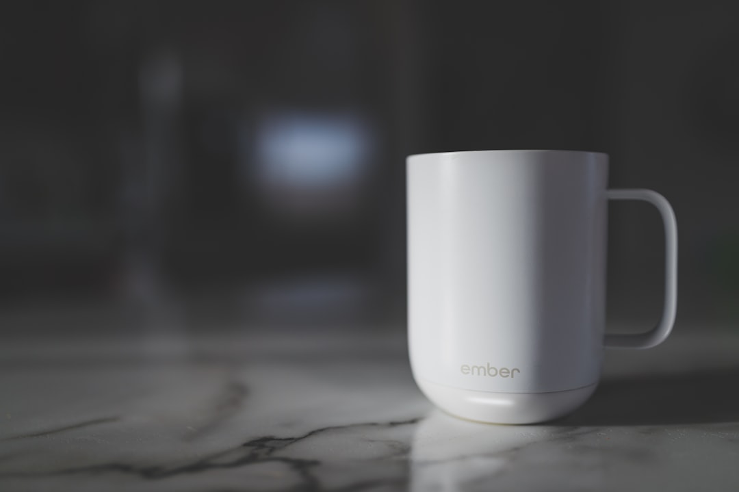 a white mug sitting on top of a marble counter