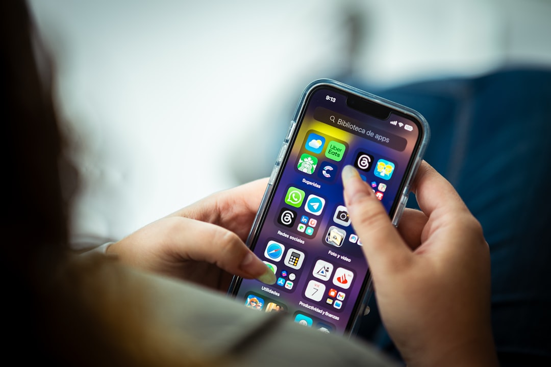 a person holding a cell phone in their hands