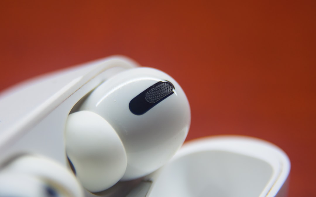 white apple earpods on orange surface