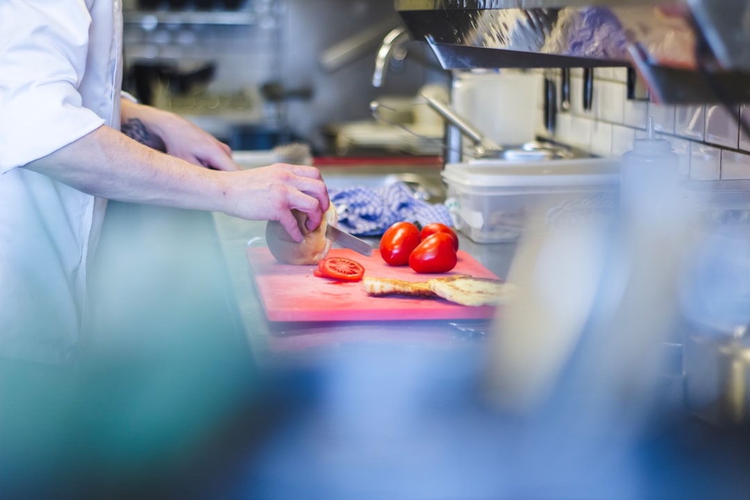 person slicing tomatoes