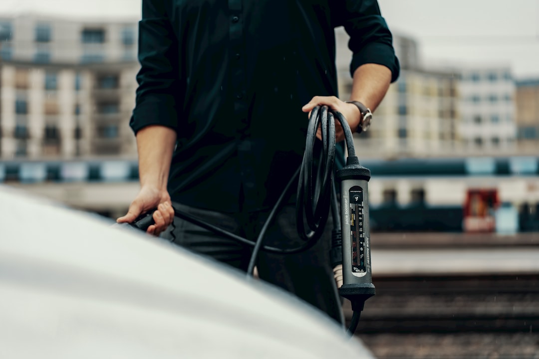 a man holding a black object in his hand