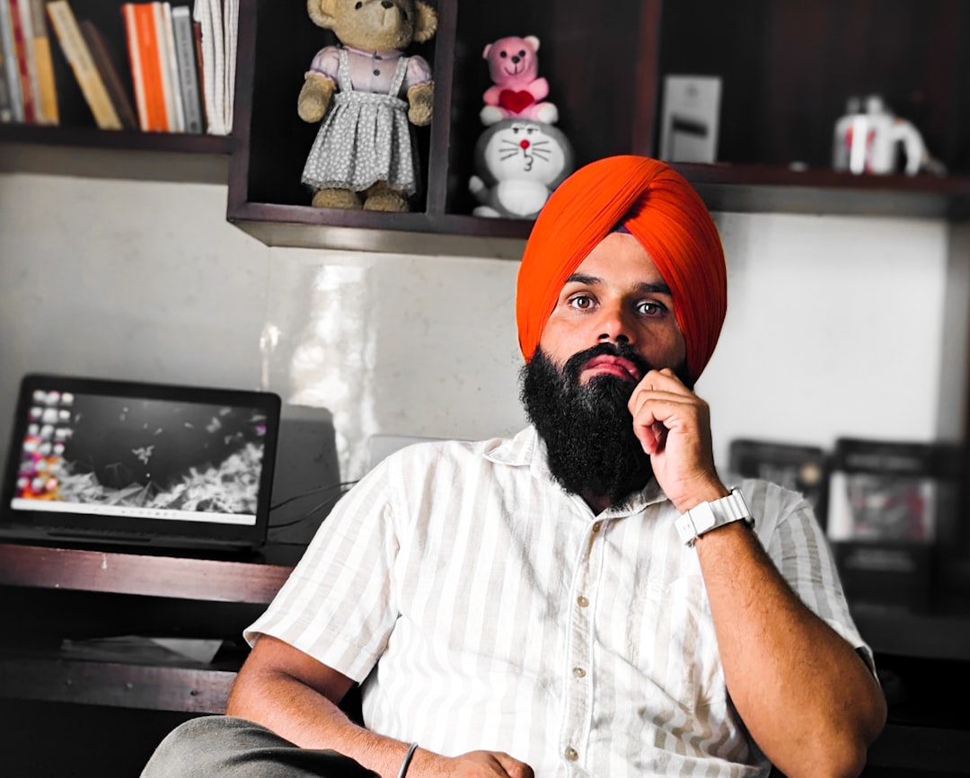 a man with a turban sitting in a chair