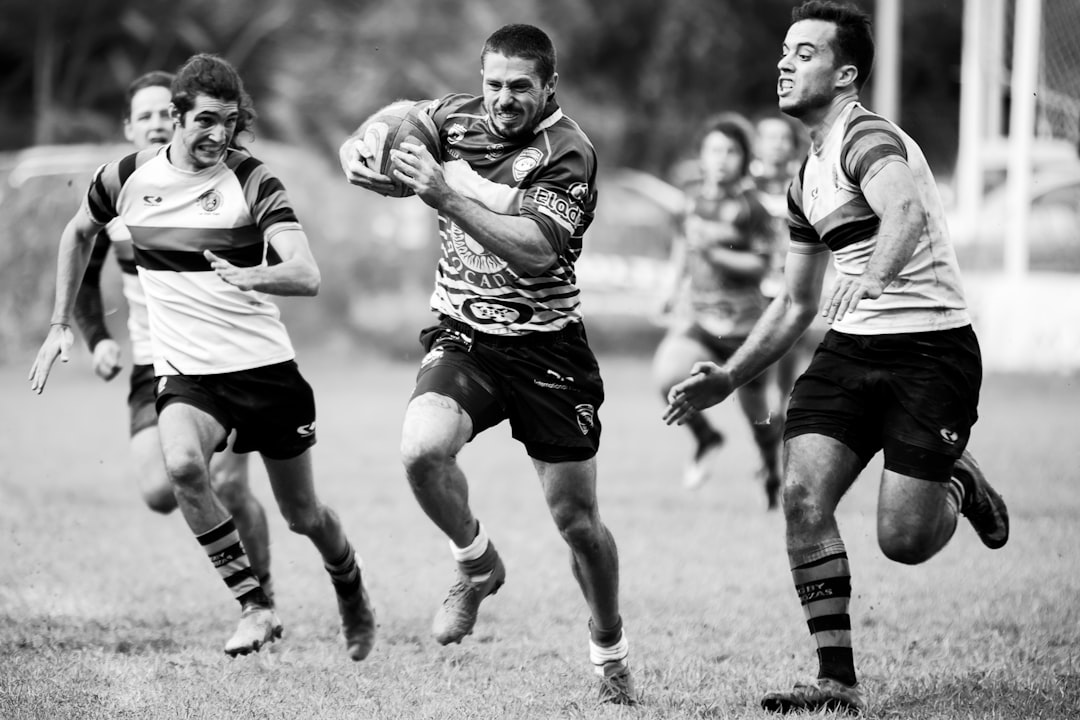 grayscale photography of men playing rugby