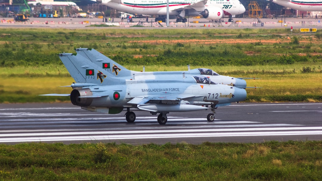 a fighter jet sitting on top of an airport runway