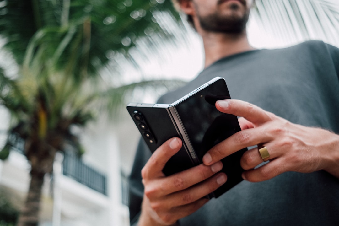 a man holding a smart phone in his hands