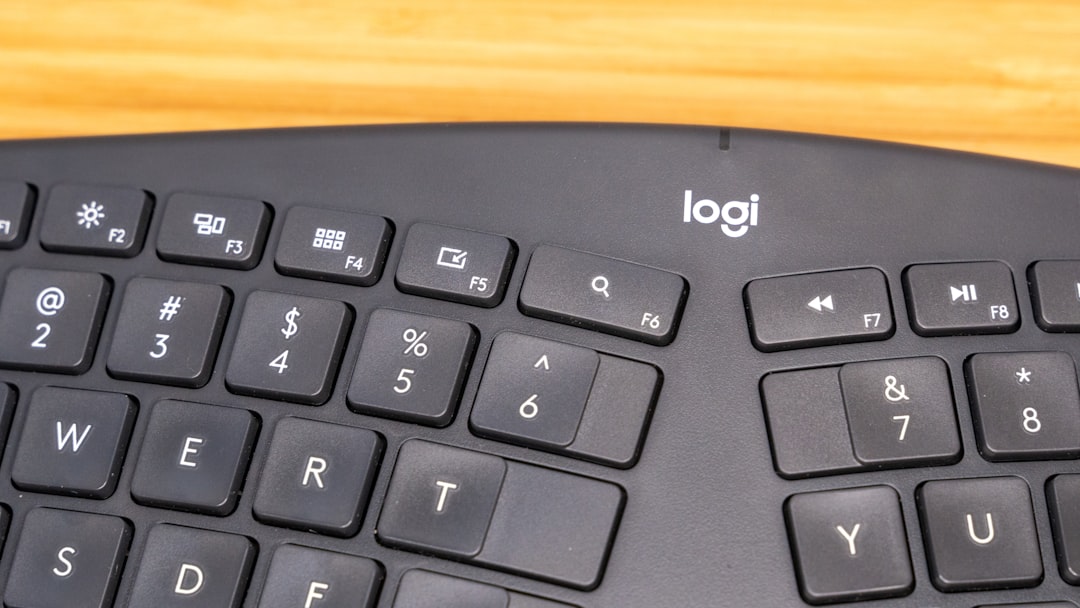 black computer keyboard on brown wooden table