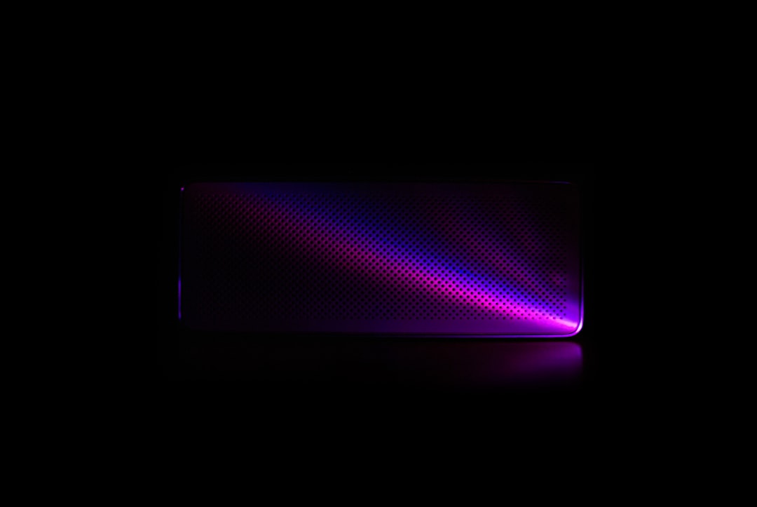 a black background with a purple and red light