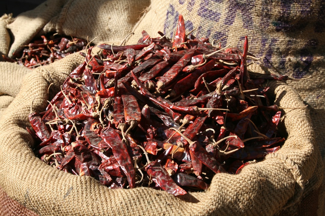 A sack full of dried red peppers sitting on top of a table