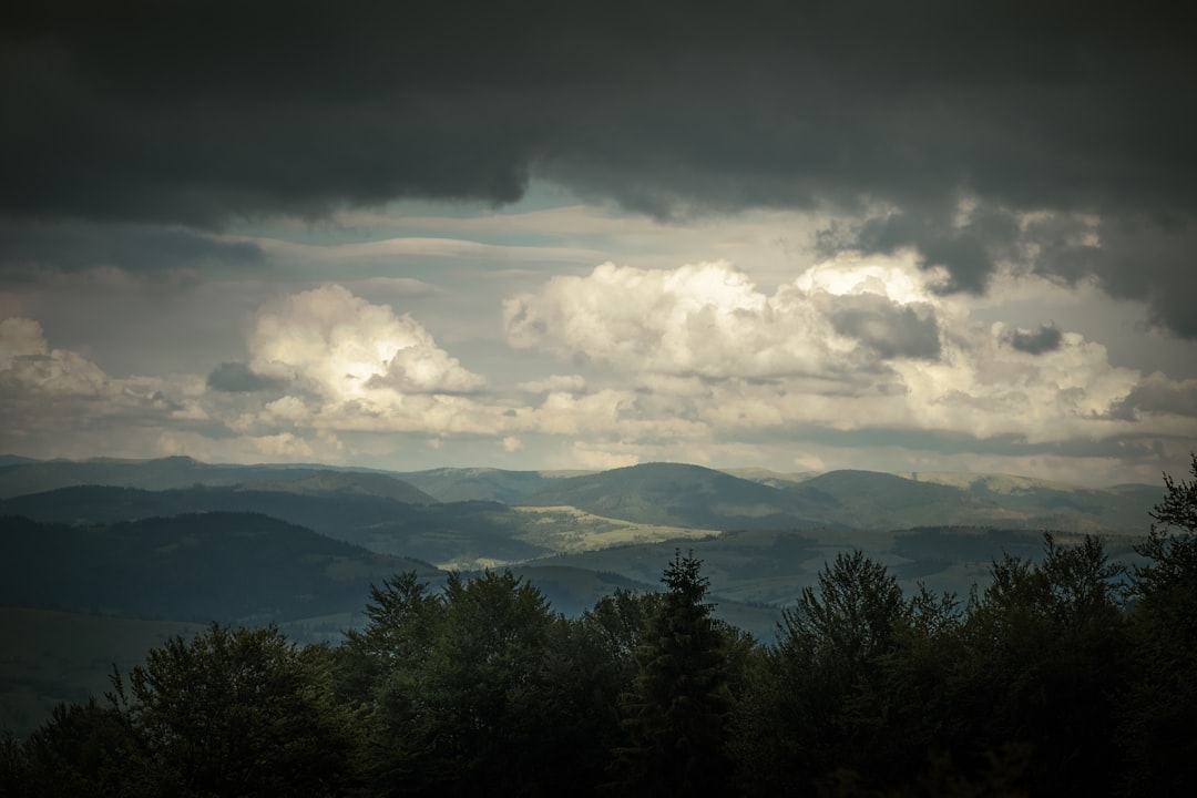 a view of a mountain range with clouds in the sky