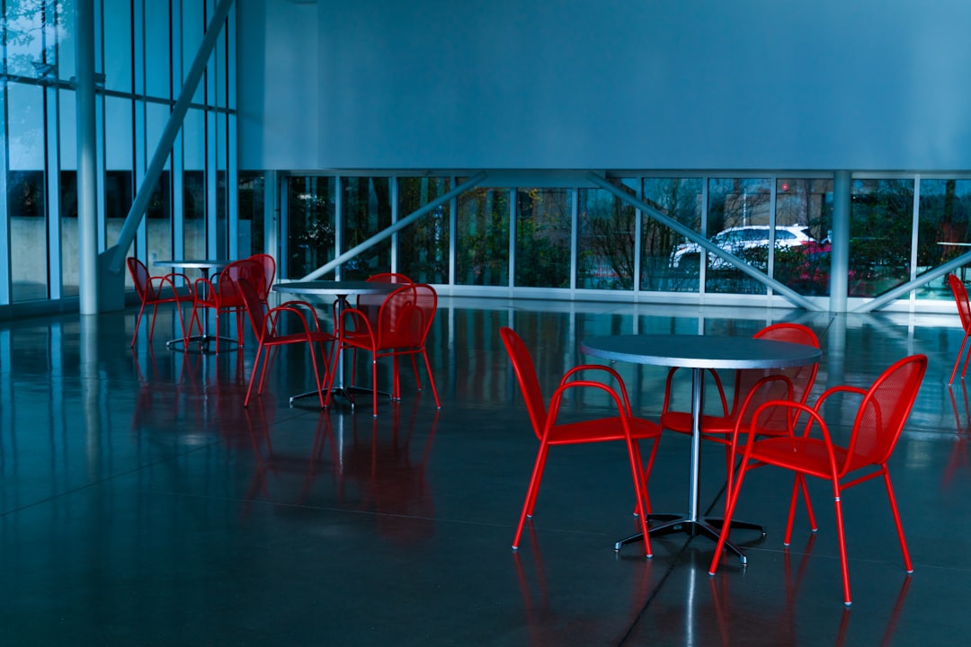 A room filled with lots of red chairs and tables