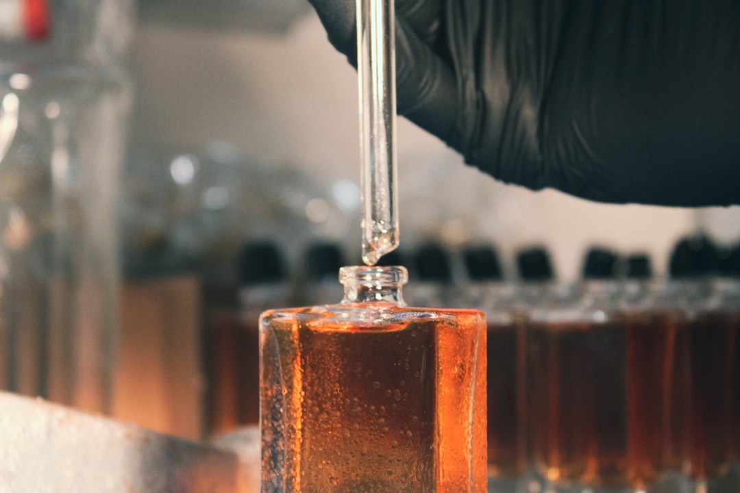 a person in a lab coat is holding a test tube with liquid in it