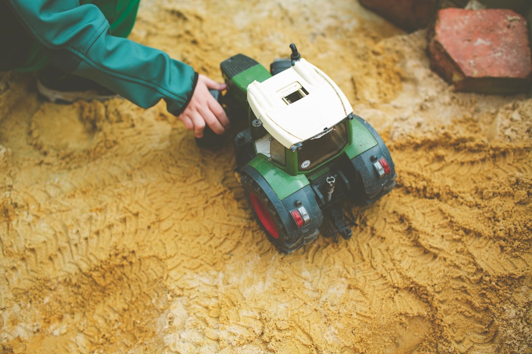 a small toy truck sitting on top of a dirt field