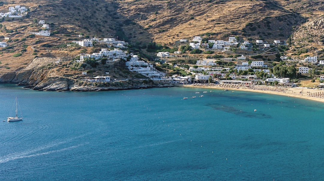 an aerial view of a beach with a boat in the water