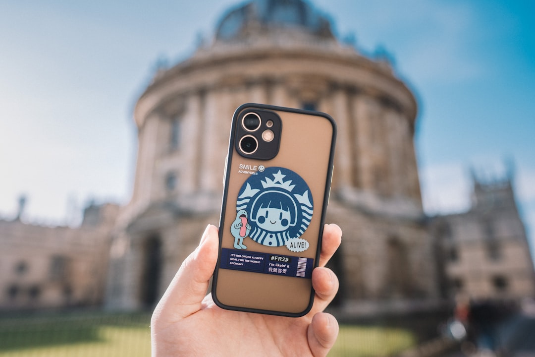 person holding iphone with blue and white case