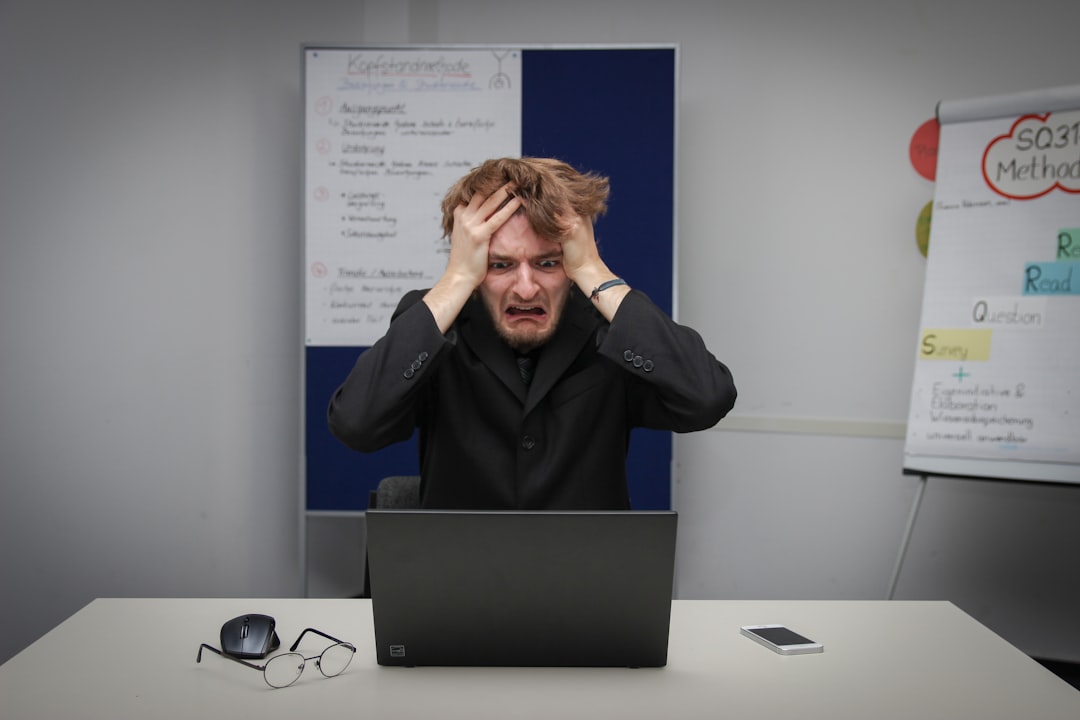 A man sitting in front of a laptop computer