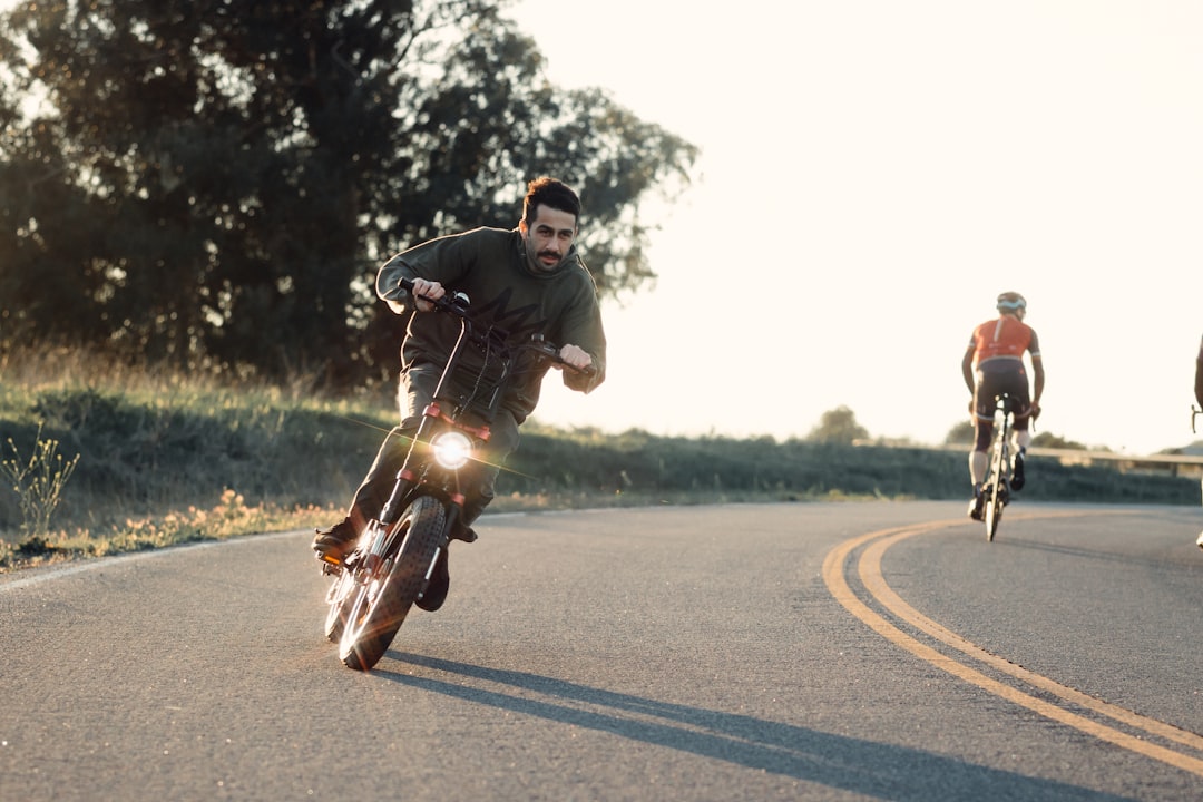 a man riding a motorcycle down a curvy road