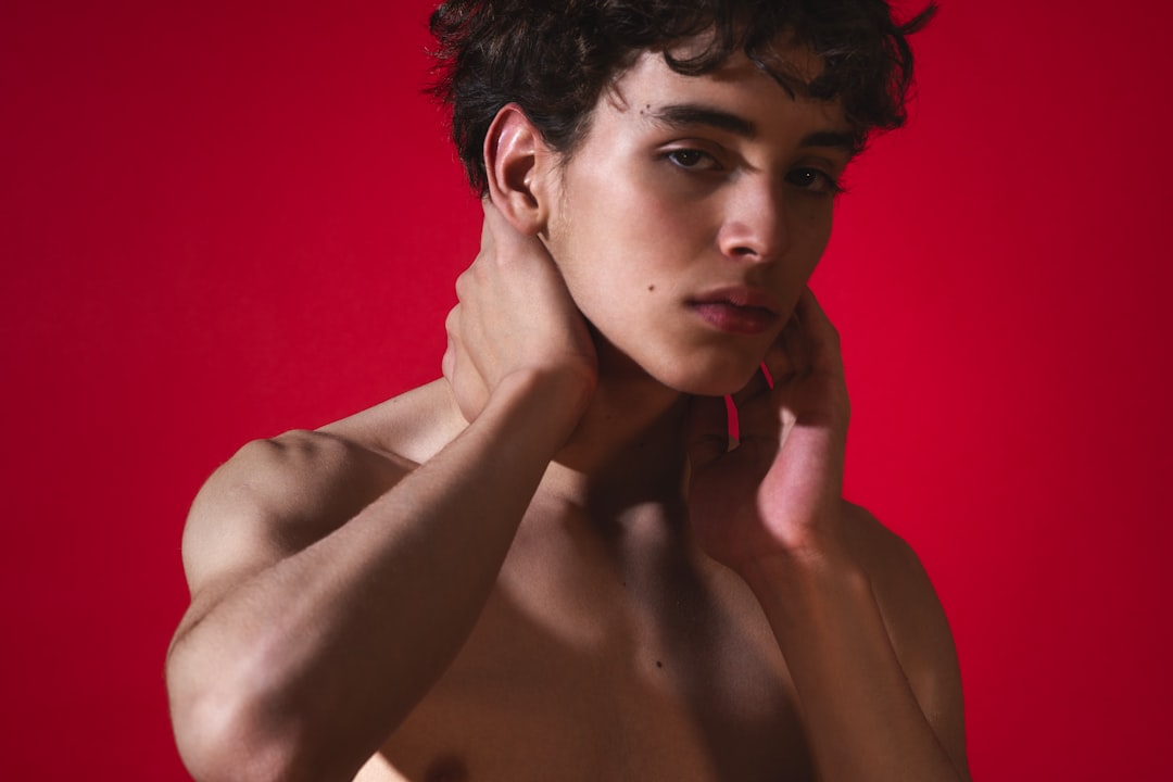 A shirtless young man posing for a picture