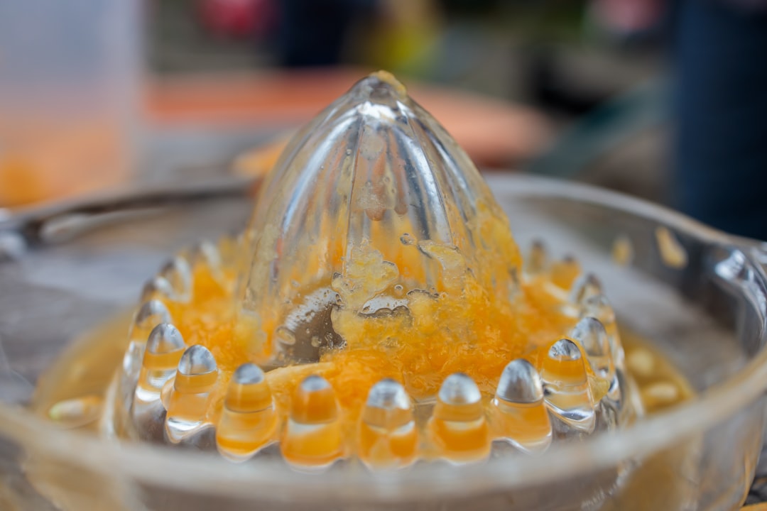 a close up of a blender filled with orange juice