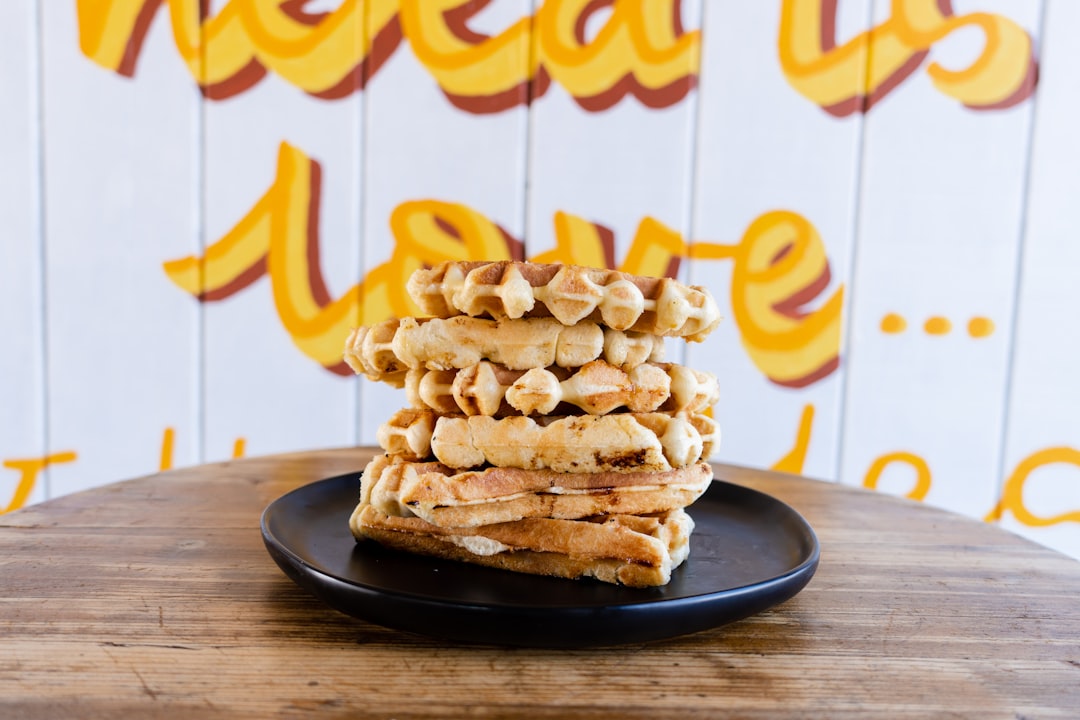 a stack of waffles sitting on top of a black plate