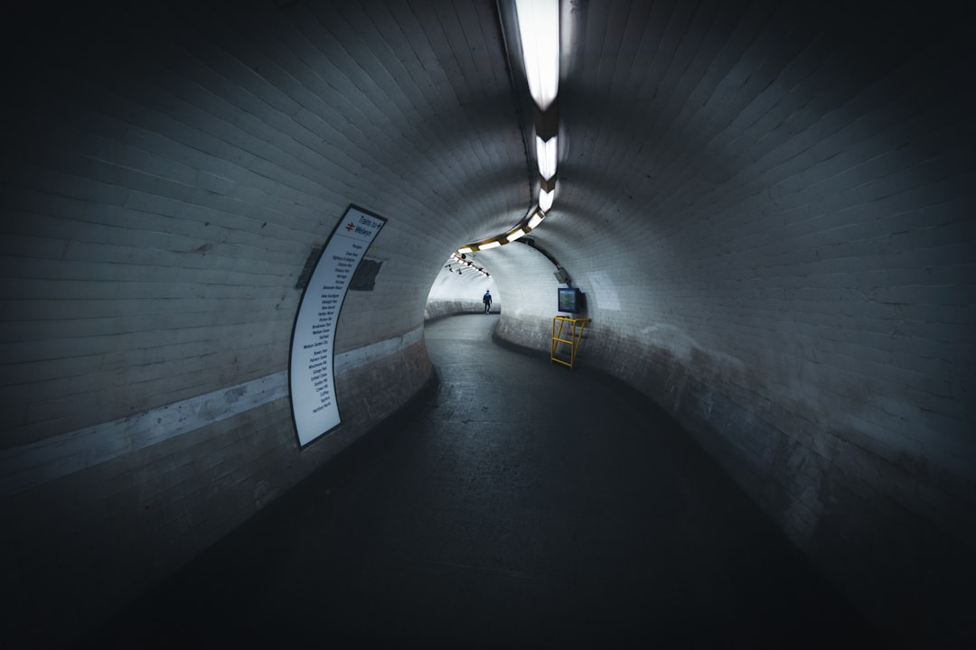 a dark tunnel with a sign in the middle