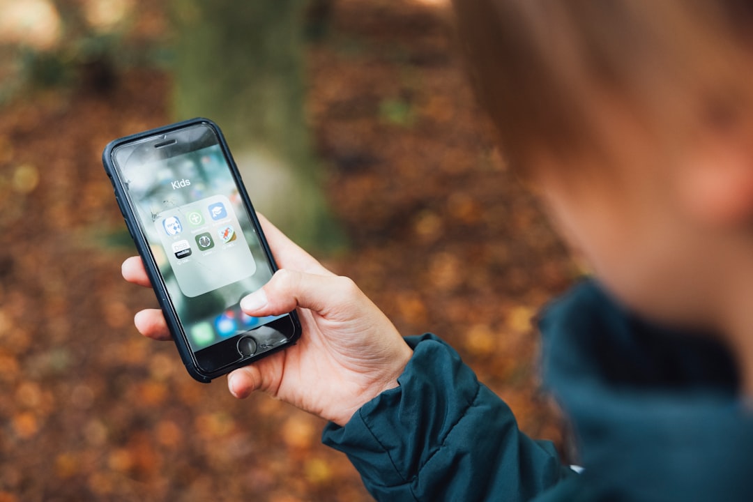 a person holding a cell phone in their hand