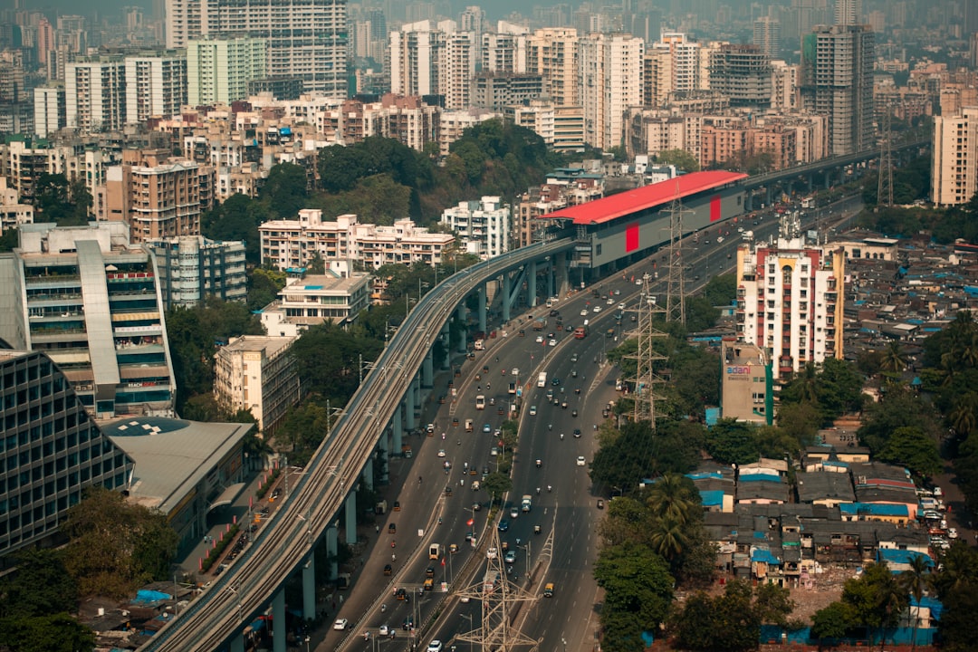 an aerial view of a city with a train on the tracks